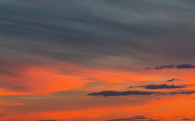 Beautiful sunset sky with orange colored clouds.