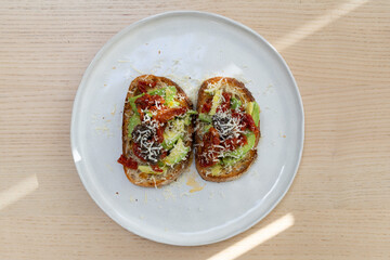 Toasted bread with sundried tomato, avocado, and cheese.