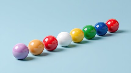 Colorful glossy spheres arranged in a rainbow pattern on a light blue background perfect for design, decoration, or educational purposes in various settings