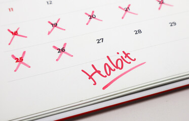 Daily habit tracking on a calendar with red marks, symbolizing consistent effort and dedication towards personal goals