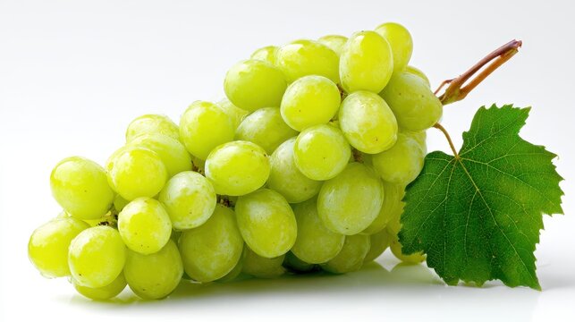 Fresh green grapes bunch with a vibrant leaf isolated on white background