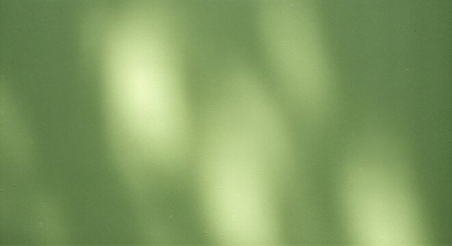 Abstract green background with soft light and blurred shapes.