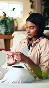 Home, manicure and woman with nail file, relax and shape edges with tool and notification on mobile. Check, smartphone and Indian person with buffer for grooming process, polish and self care on sofa