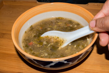 serving veg lemon coriander soup on wooden tray.