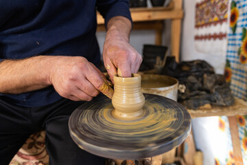 Skilled Potter Shaping Clay on a Wheel