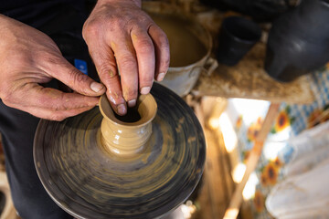 Skilled Potter Shaping Clay on a Wheel