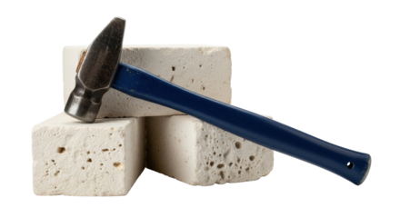 Isolated hammer with a blue handle resting on stacked construction blocks, still life