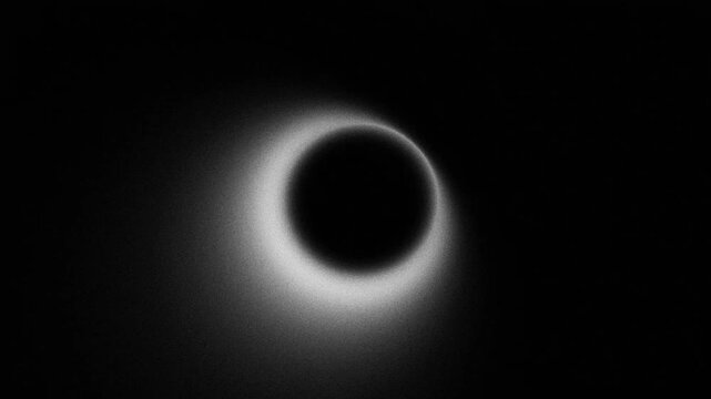 Abstract blurry pulsing ring shape with grainy orange gradient and noise texture, looping animation on black background