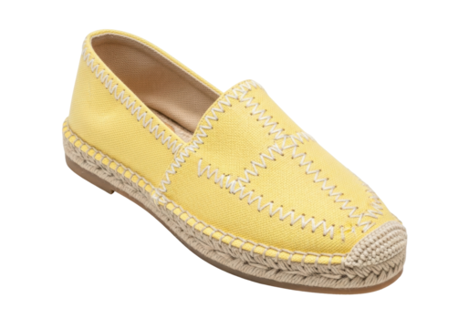 Isolated Espadrille shoe with yellow canvas and stitched jute sole on neutral backdrop