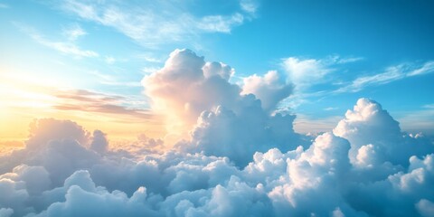 Beautiful fluffy white cumulus clouds with sun setting over blue sky. Dreamy horizon view from above. Peaceful nature background.