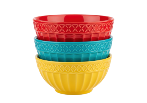 Isolated stack of vibrant ceramic bowls in red, blue and yellow colors, kitchen utensils
