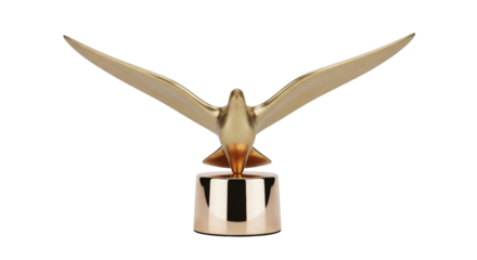 Isolated golden bird sculpture, flying with wide spread wings, awards trophy on base, gold toned