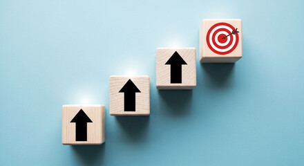 Wooden blocks with arrow up and target sign, business growth success process concept idea