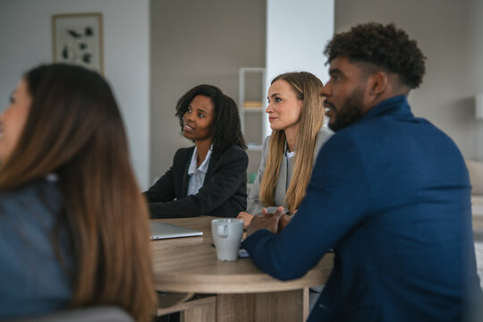 Diverse business professionals attending corporate meeting at office - Powered by Adobe