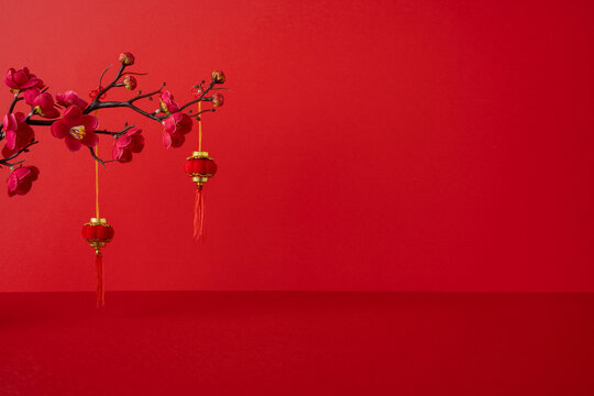 Side view of red Chinese New Year scene with plum blossoms and lanterns, festive mood, greeting luck prosperity, tradition symbols, celebration mood - Powered by Adobe