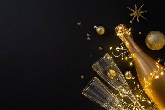 A festive scene features a champagne bottle, elegant glasses, and warm string lights beside gold ornaments against a dark backdrop, conveying holiday celebration, luxury glow, and seasonal joy