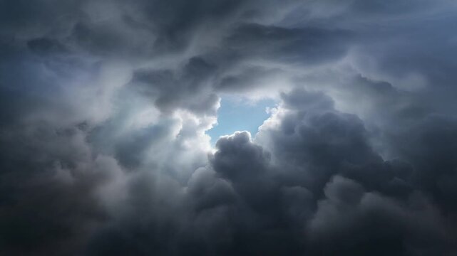 A powerful celestial scene where ominous storm clouds part to unveil a radiant patch of clear sky, representing resilience and new beginnings
