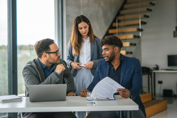 Diverse business team collaborating on project in office