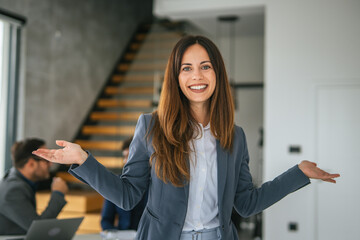 Fototapeta premium Professional businesswoman welcoming clients in modern office building