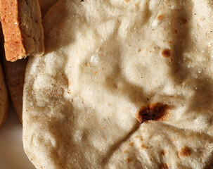 Close Up Of Egyptian Aish Baladi Flatbread With Crumbled Food On The Side