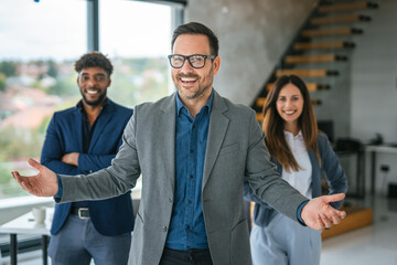 Diverse business team welcoming clients in modern office