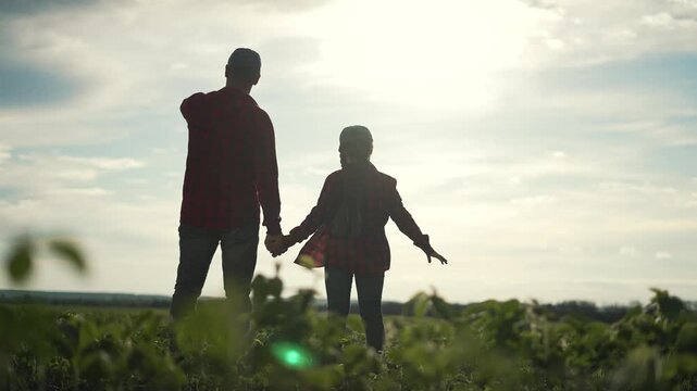 Happy Family exploring soybean business outdoors. Father and daughter bonding in field. Learning soybean farming together. Happy family in soybean field. Father teaching business concepts outdoors.