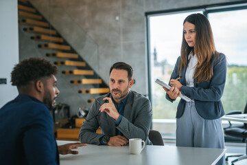 Business professionals conducting job interview with male candidate
