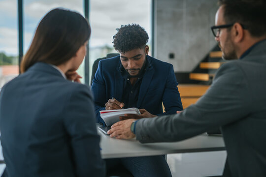 Professionals discussing new business contract terms in office