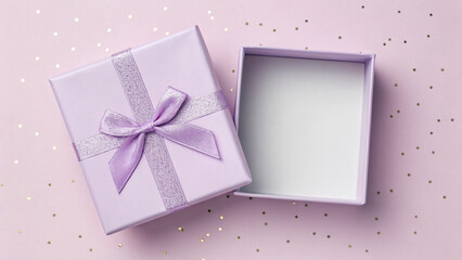 A beautifully wrapped purple gift box sits open against a pale pink background adorned with gold and silver sparkles