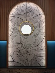A stylish interior wall feature, combining natural wood panels, a modern spherical light fixture...