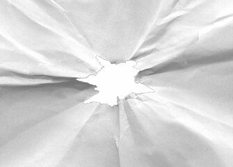 Hole in crumpled paper with torn edges isolated on transparent background.