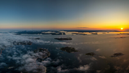 Naklejka premium aerial panorama view of a beautiful sunset over the skerries and islands of the Aland archipelago in the Baltic Sea