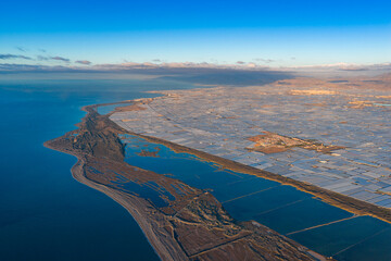 The "Sea of Plastic" Megastructure: Panoramic Aerial View of Vast Greenhouses Lining the Mediterranean Coast of Andalusia, Highlighting Global Food Production and Climate Change