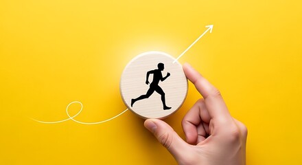 Hand holding a wooden disc with a running man icon on a yellow background