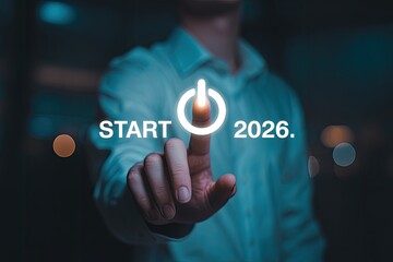 Start 2026 technology concept with glowing power button touched by businessman