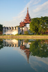 A turret above the ancient fortress wall of the old town on a sunny morning. Mandalay, Myanmar