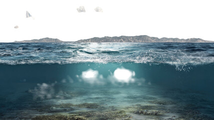 Waves of blue ocean water splash on the summer beach coast under a vast blue sky