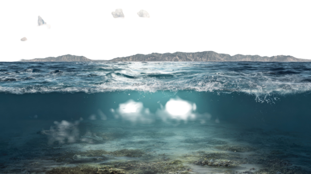 Waves of blue ocean water splash on the summer beach coast under a vast blue sky