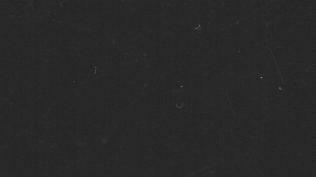 Cinematic analog film grain loop with subtle grind texture and dust artifacts. Ideal as an overlay or background for editors seeking authentic retro aesthetics in horizontal format.