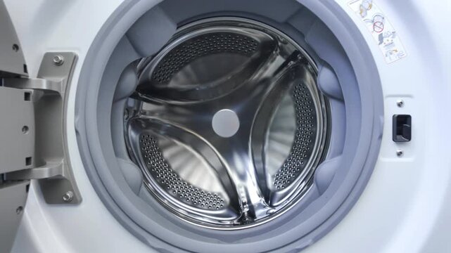 Moving Into a Washing Machine Drum as Cycle Begins.
Point-of-view footage entering the interior of a front-loading washing machine.