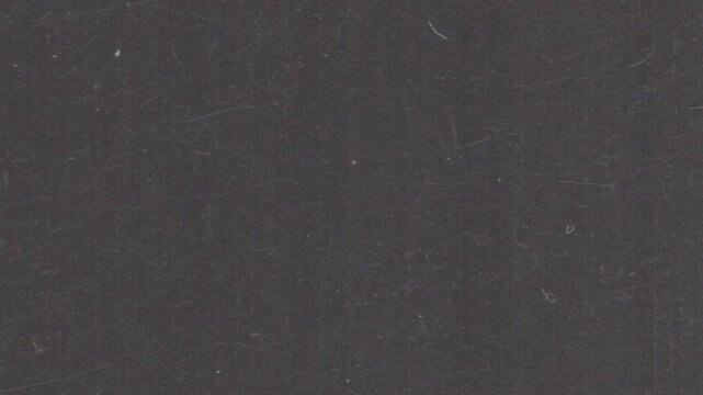 Cinematic analog film grain loop with subtle grind texture and dust artifacts. Ideal as an overlay or background for editors seeking authentic retro aesthetics in horizontal format.