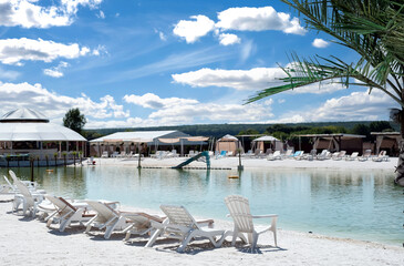 Recreation complex with sun loungers and a covered tent with a pond