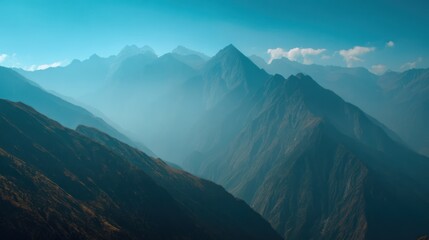 Fototapeta premium Serene Mountain Landscape with Misty Peaks and Blue Sky