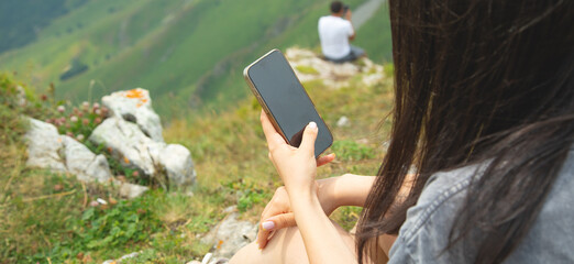 Caucasian woman using mobile phone in outdoors.