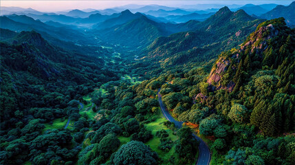 Wide aerial panorama of lush Korean mountains and valley with winding scenic road