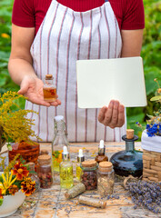 Medicinal herbs on the table. Place for notepad text. woman. Selective focus.