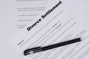 Marital Settlement Separation Divorce Agreement paper document with wedding rings on table, symbolizing divorce, prenuptial contract, prenup, breakup for United Kindom (UK).