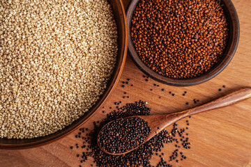 Variety of Quinoa Grains White Red and Black on a Wooden Surface