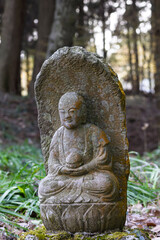 Little weathered Gautama Buddha sculpture plaque covered with lichens, Saigandenji Temple in little village Aso Kumamoto perfecture in Japan