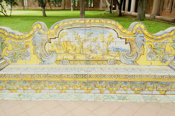 View of a bench in the cloister of Santa Chiara with azulejos in Naples, Campania, Italy.